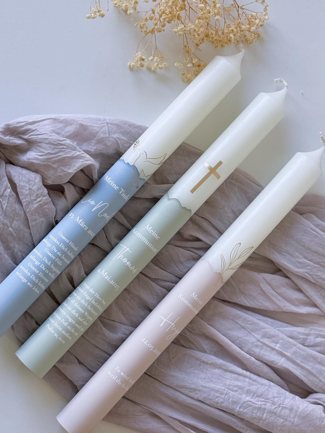 Communion candle or baptism candle with golden symbol and name, date and baptismal saying